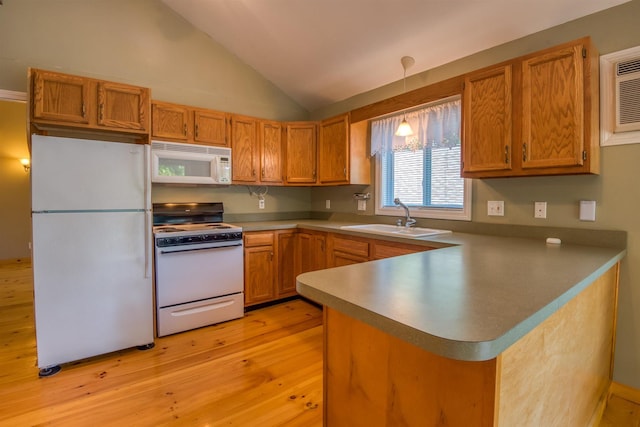 kitchen with white appliances, a sink, light wood-style flooring, vaulted ceiling, and a peninsula