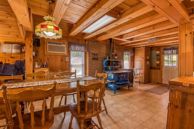 dining space featuring a wood stove, wood ceiling, beam ceiling, an AC wall unit, and wooden walls