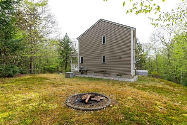 108 Brenner Dr, Conway, NH 03818 - rear view of house with cooling unit, a fire pit, and a lawn