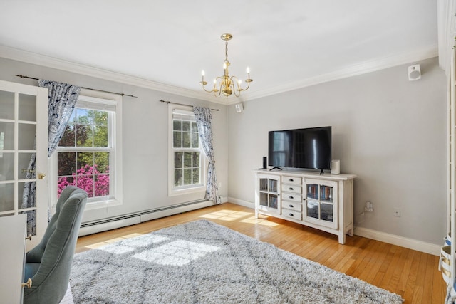 living area with baseboard heating, a chandelier, crown molding, hardwood / wood-style floors, and baseboards