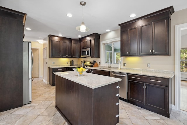 kitchen with appliances with stainless steel finishes, a sink, light tile patterned flooring, dark brown cabinets, and recessed lighting