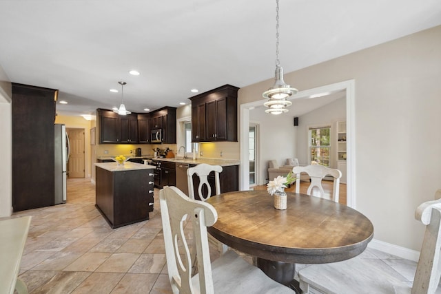 dining area featuring a chandelier, recessed lighting, and baseboards