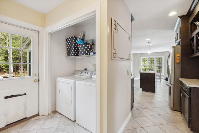laundry area featuring washer and clothes dryer, light tile patterned floors, baseboards, and recessed lighting