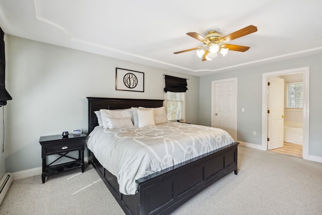 bedroom with multiple windows, light colored carpet, and baseboards
