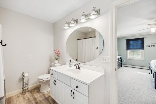 full bath with baseboard heating, vanity, ceiling fan, baseboards, and toilet
