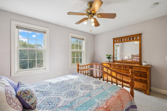bedroom with baseboards, carpet floors, and ceiling fan