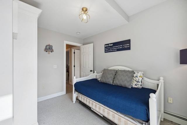 carpeted bedroom with baseboard heating and baseboards