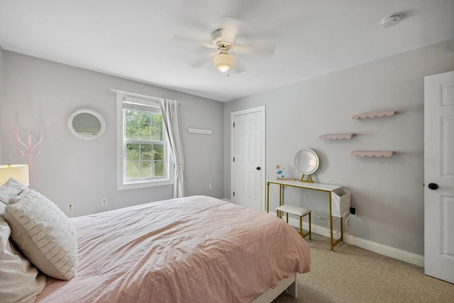 bedroom with carpet flooring, baseboards, and a ceiling fan