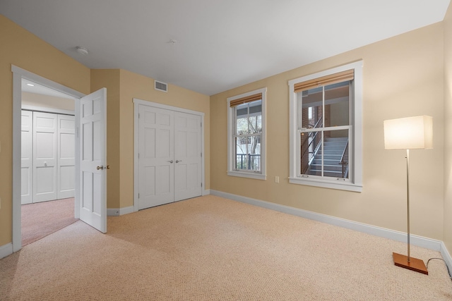40 College St Unit 210, Burlington, VT 05401 - unfurnished bedroom featuring carpet floors, baseboards, and a closet