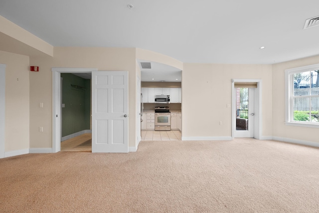 40 College St Unit 210, Burlington, VT 05401 - unfurnished living room featuring light carpet, baseboards, and recessed lighting