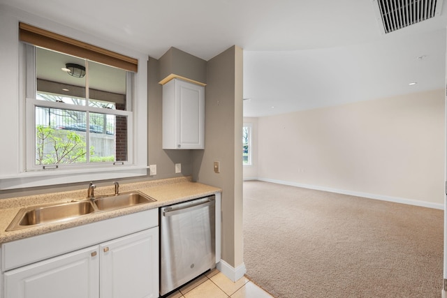 40 College St Unit 210, Burlington, VT 05401 - kitchen with stainless steel dishwasher, a sink, light carpet, light countertops, and white cabinets