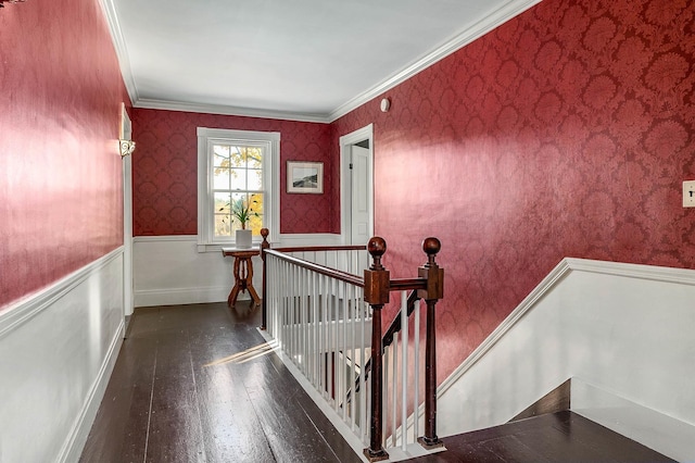 stairway with hardwood / wood-style floors, crown molding, a wainscoted wall, and wallpapered walls