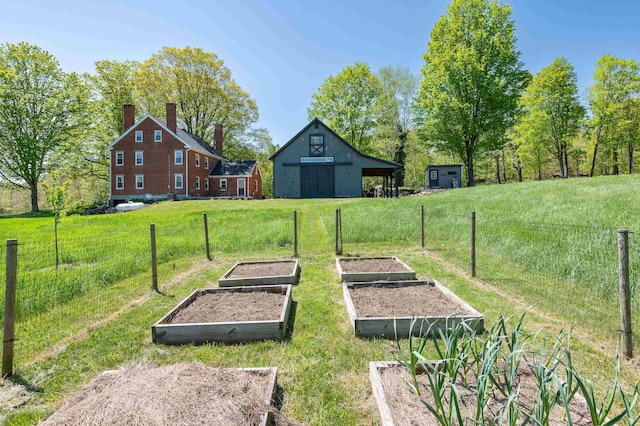 view of yard featuring a garden and an outbuilding