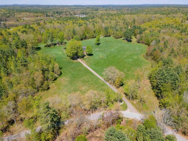 aerial overview of property's location with a heavily wooded area