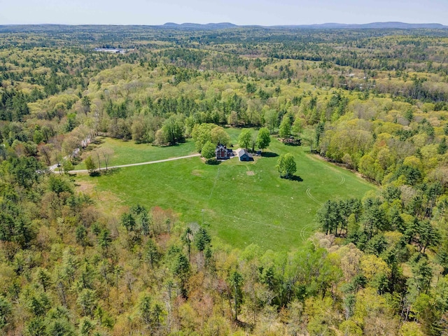 aerial view of property and surrounding area featuring a forest