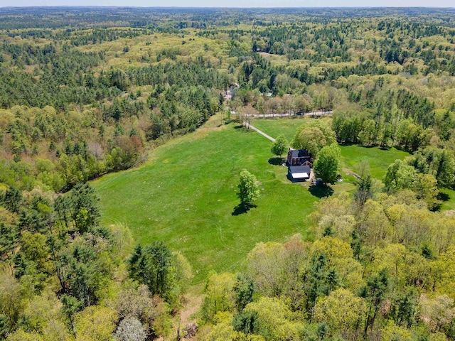 view of property location with a forest and rural landscape