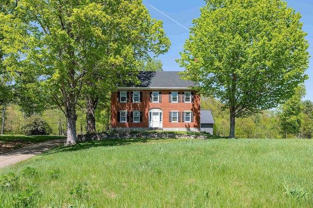 colonial inspired home with brick siding
