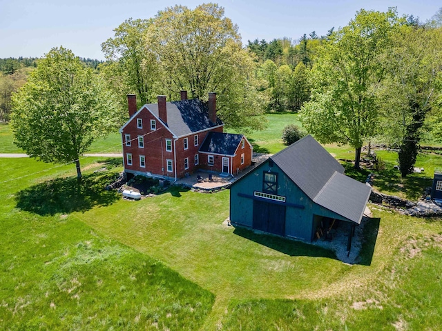 aerial view of property and surrounding area featuring a forest