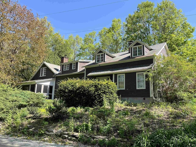 view of property exterior with a chimney