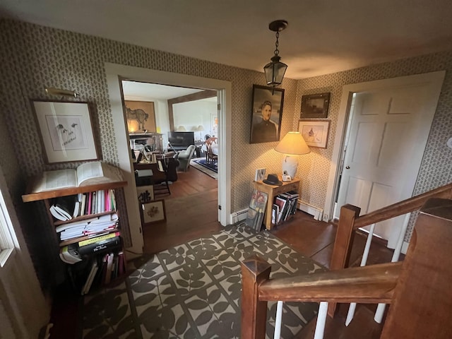 hall featuring wallpapered walls, baseboard heating, an office area, and baseboards