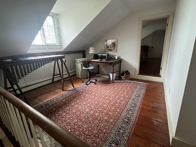 home office featuring hardwood / wood-style flooring, lofted ceiling, and a baseboard heating unit