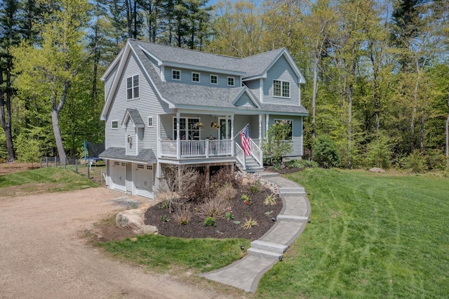 view of front of home with a porch, roof with shingles, an attached garage, dirt driveway, and a front yard