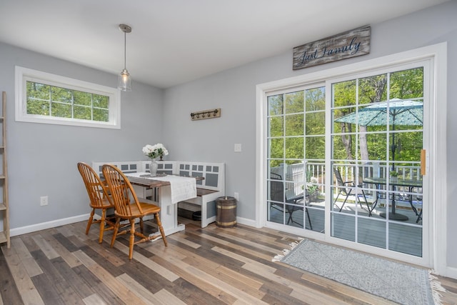 dining area featuring healthy amount of natural light, wood finished floors, and baseboards