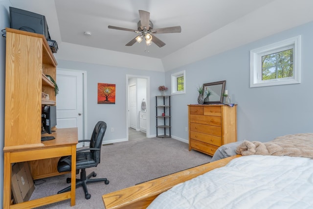 bedroom with an office area, light carpet, baseboards, and a ceiling fan