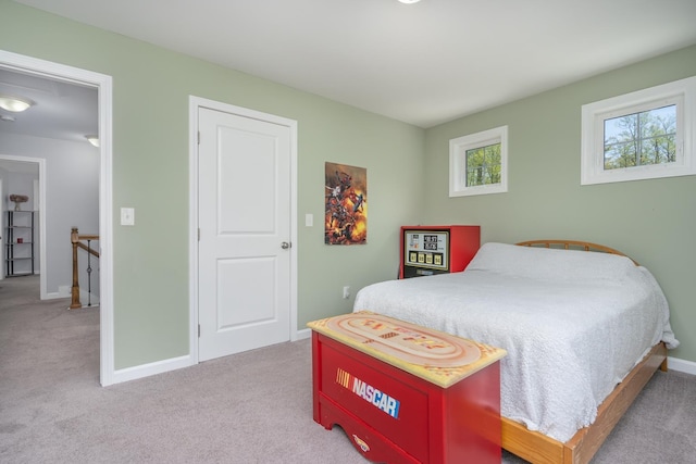 carpeted bedroom featuring baseboards
