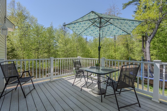 wooden deck featuring outdoor dining area