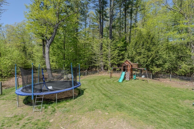view of yard with a trampoline and a playground