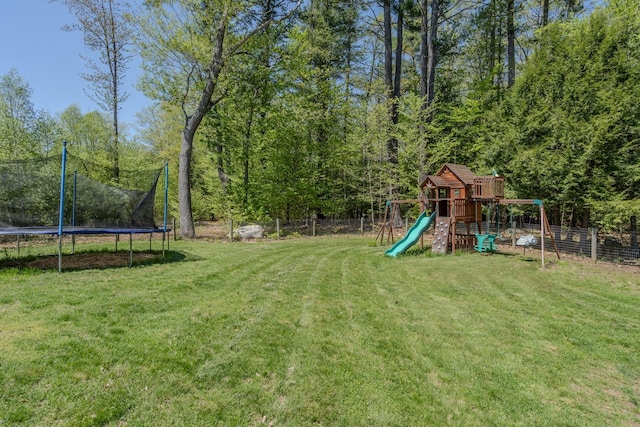 view of yard with a playground and a trampoline