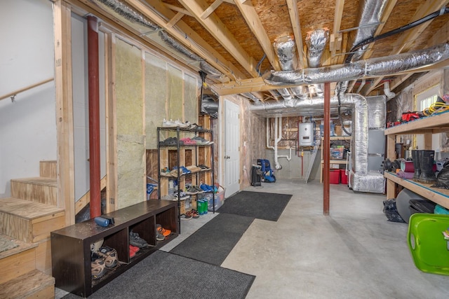 unfinished below grade area featuring heating unit, stairs, and water heater