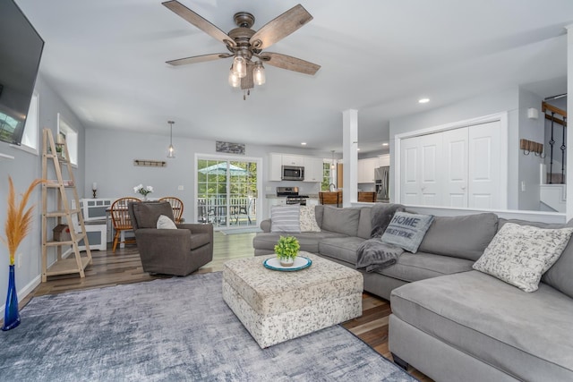 living area featuring wood finished floors, a ceiling fan, recessed lighting, and baseboards