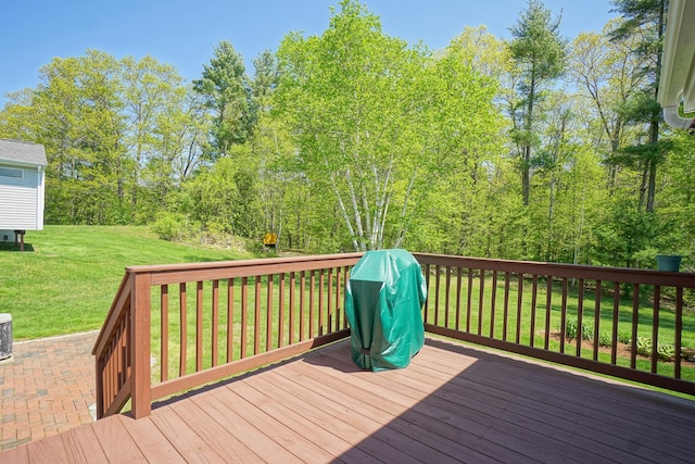 wooden deck with a lawn and grilling area