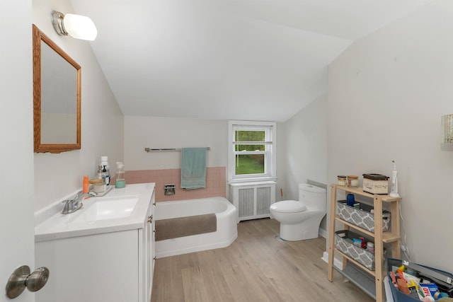 74 Pine St, Rollinsford, NH 03869 - bathroom featuring toilet, lofted ceiling, radiator, wood finished floors, and vanity