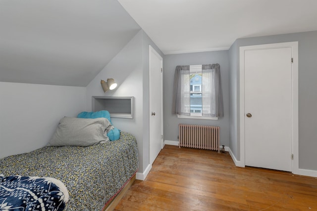 74 Pine St, Rollinsford, NH 03869 - bedroom with radiator heating unit, light wood-style floors, and baseboards