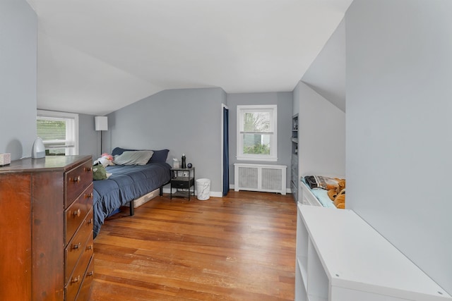 74 Pine St, Rollinsford, NH 03869 - bedroom with radiator heating unit, light wood-style floors, lofted ceiling, multiple windows, and baseboards