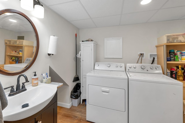 74 Pine St, Rollinsford, NH 03869 - laundry room with washing machine and dryer, a sink, light wood-style flooring, and baseboards