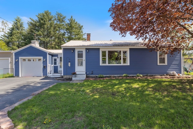 15 Schley St, Rochester, NH 03867 - view of front of property featuring a chimney, an attached garage, driveway, metal roof, and a front lawn