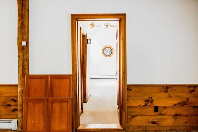 hall featuring baseboard heating and carpet