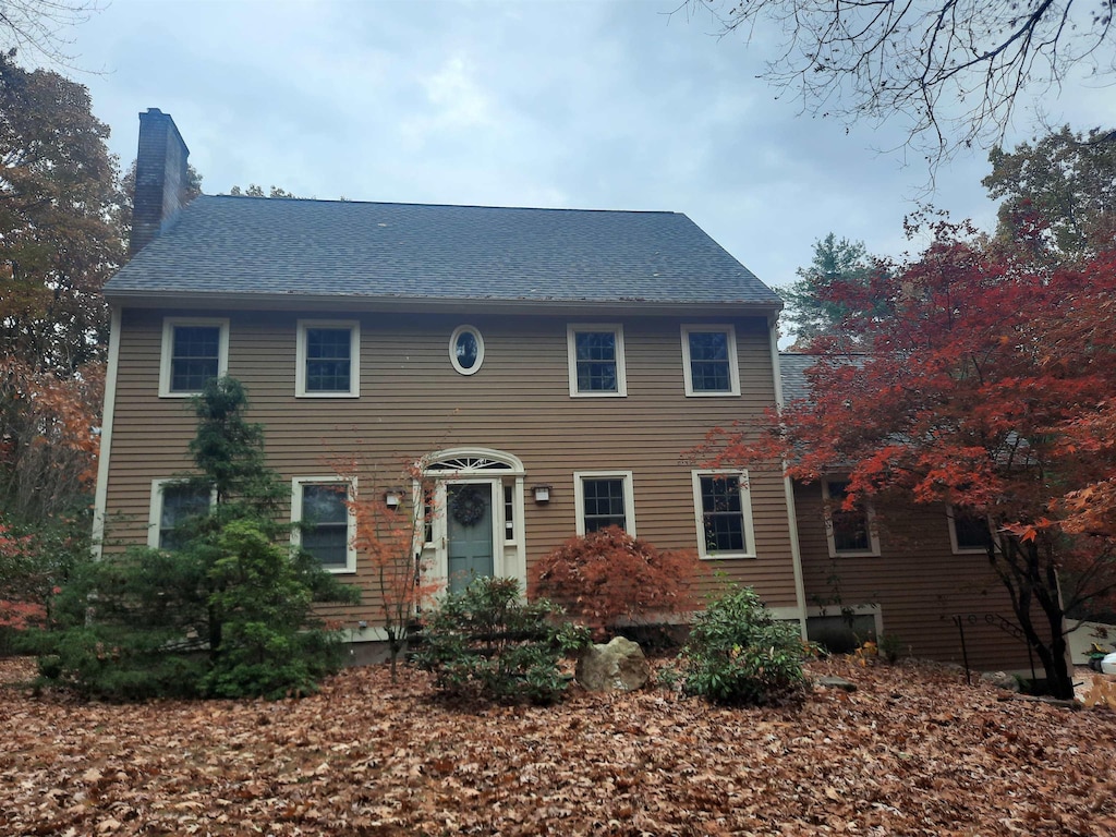 15 Alexander Rd, Londonderry, NH 03053 - colonial inspired home with a chimney and a shingled roof