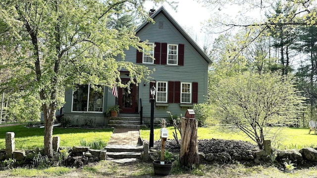 171 Stoneham Rd, Wakefield, NH 03872 - view of front of home with a front yard and a chimney