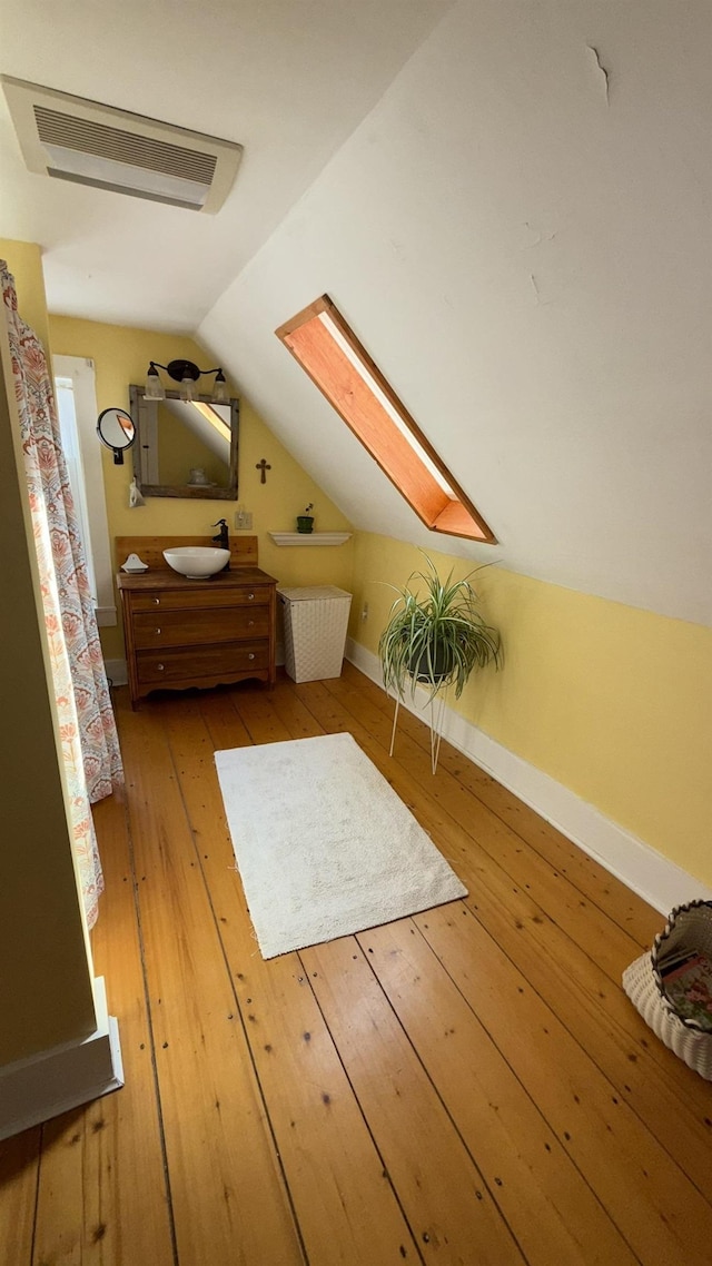 171 Stoneham Rd, Wakefield, NH 03872 - bonus room featuring a skylight, light wood-style flooring, a sink, vaulted ceiling, and baseboards