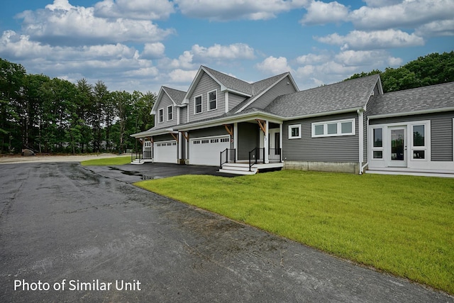 4 Fowler Dr, Rye, NH 03870 - view of front of property with a garage, driveway, a front yard, and roof with shingles