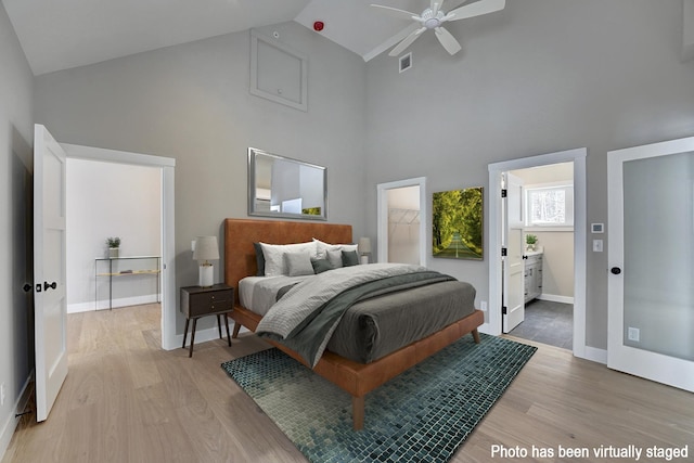 4 Fowler Dr, Rye, NH 03870 - bedroom with high vaulted ceiling, light wood-style flooring, baseboards, and ensuite bathroom