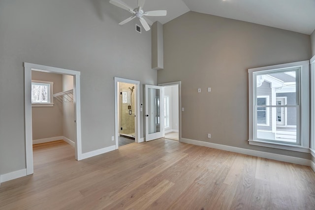 4 Fowler Dr, Rye, NH 03870 - unfurnished living room with high vaulted ceiling, baseboards, ceiling fan, and light wood-style floors