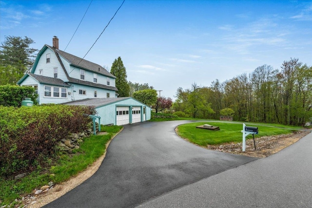 3 King Rd, Chichester, NH 03258 - view of side of property featuring a detached garage, a lawn, and a chimney