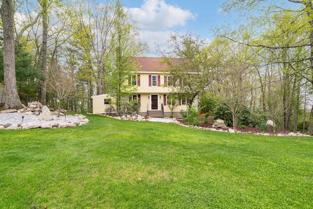 rear view of property with a yard