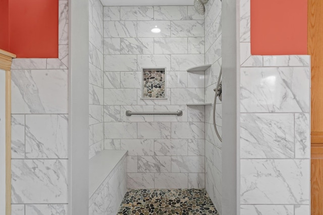 bathroom with tiled shower
